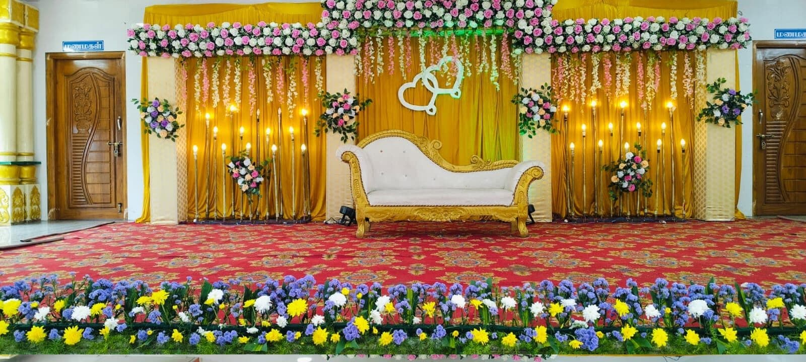 White and pink stage with fairy light canopy